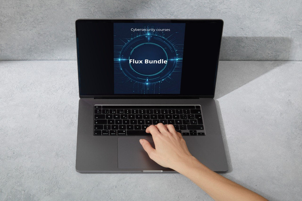 Laptop displaying cybersecurity courses with a hand on the keyboard on a gray surface
