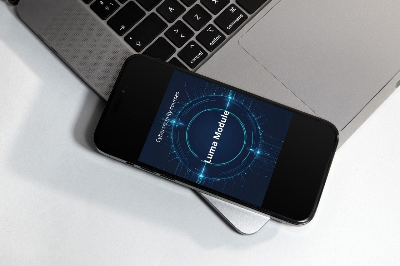 Smartphone with a futuristic app interface on a laptop keyboard