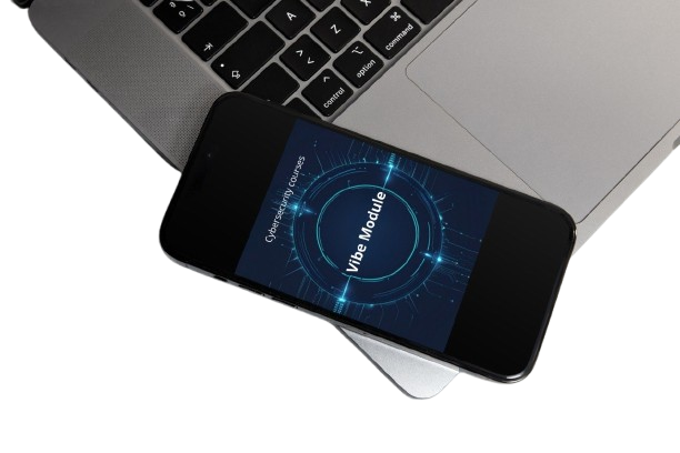 Smartphone with 'Vibe Module' displayed on screen, placed on a laptop.